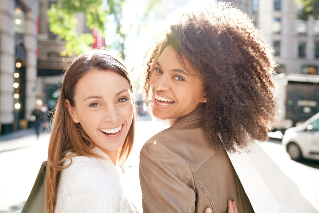 2 Happy Young Women Looking Back